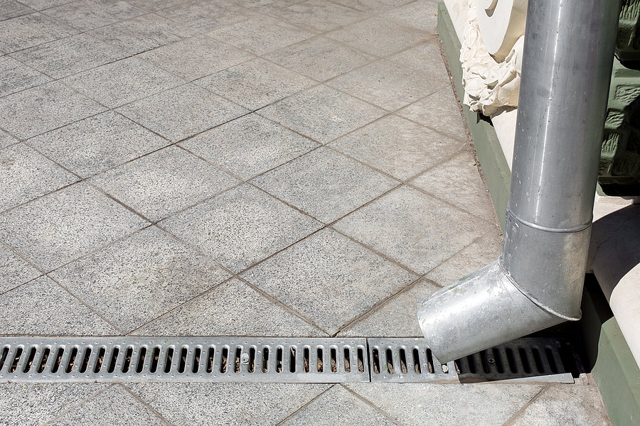 a gutter guard pointing on a drain